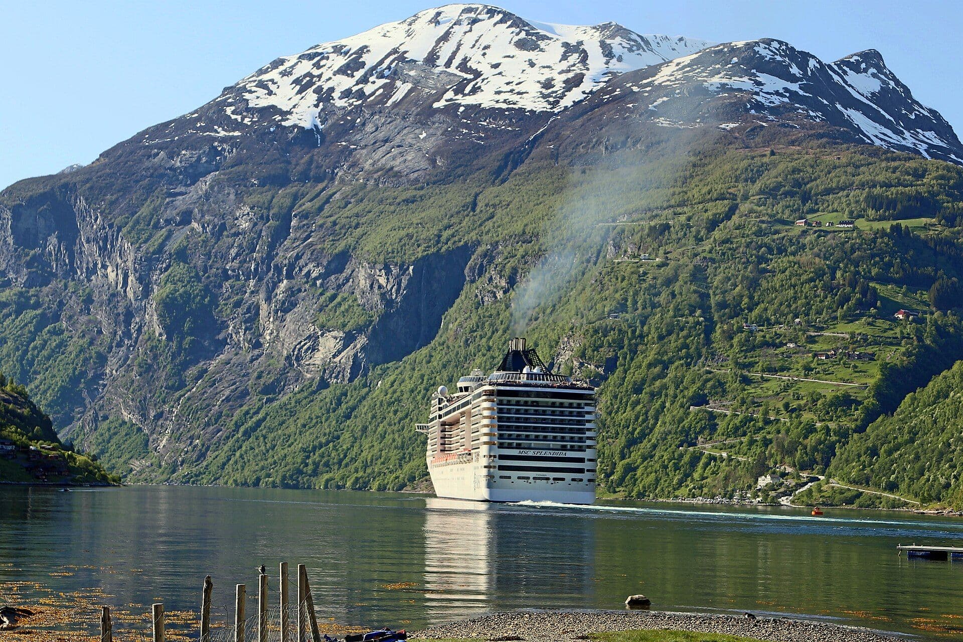 Cruise ship among fjords and peaks